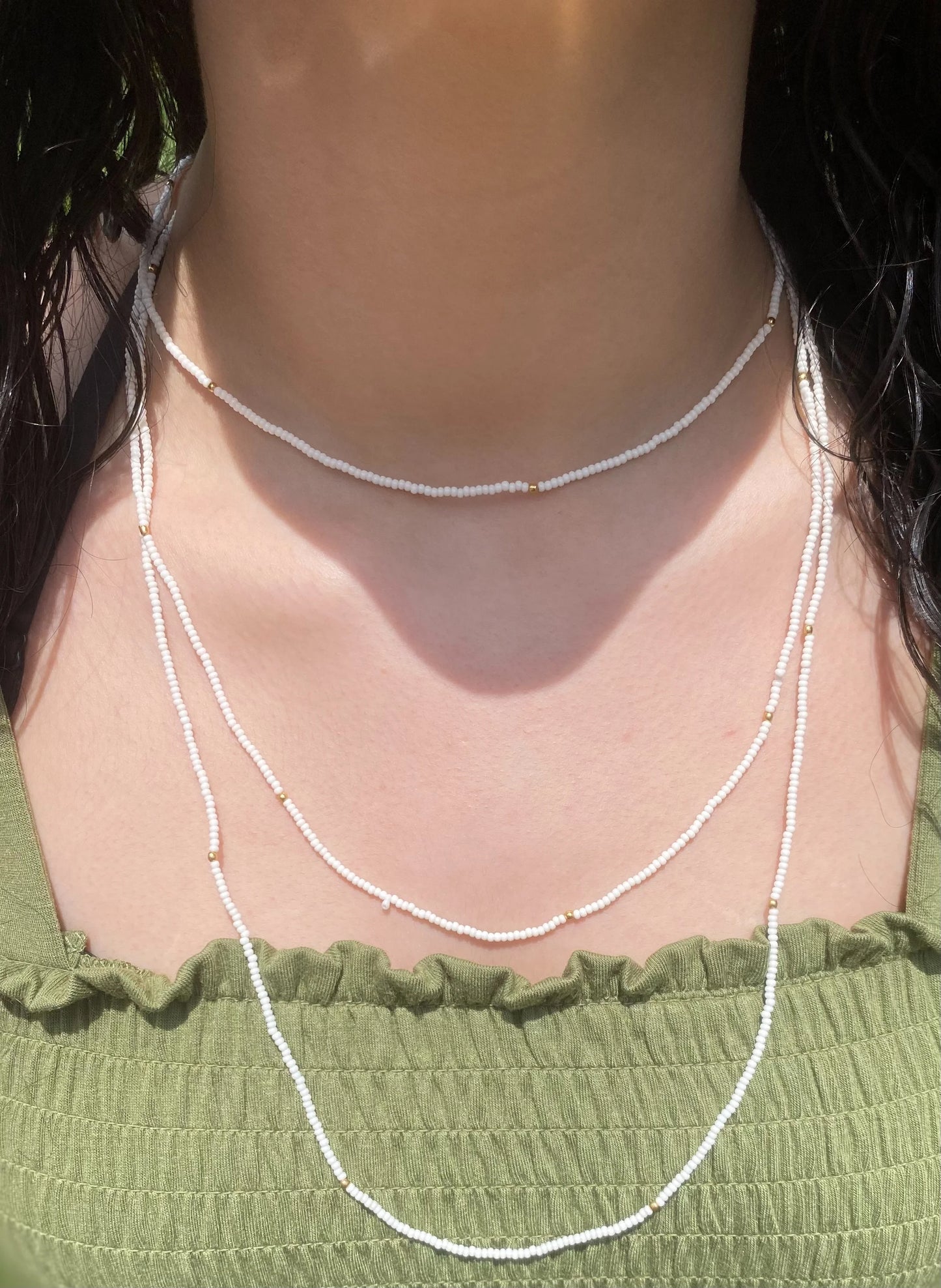 Beaded long necklace with gold tone